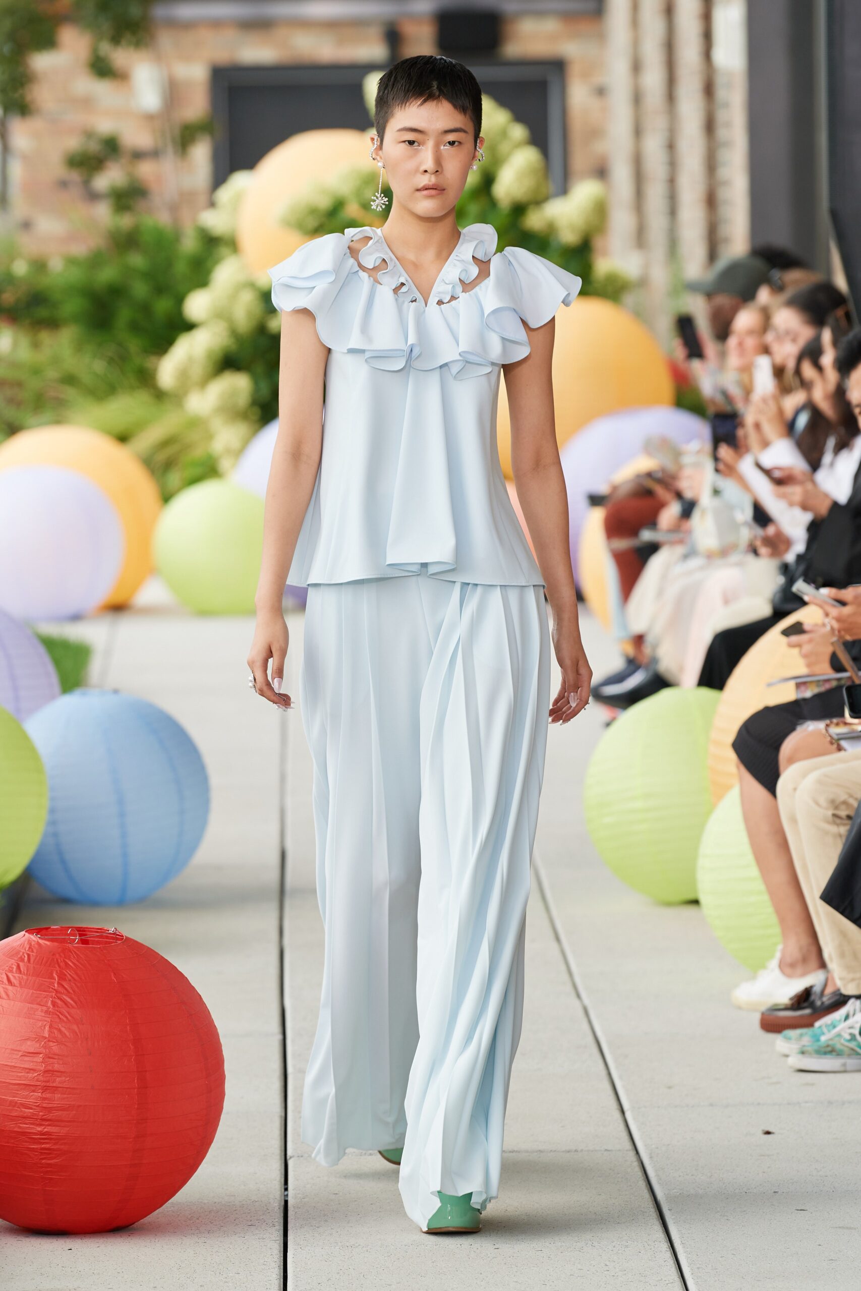 blue silk ruffled top with wide-leg pants