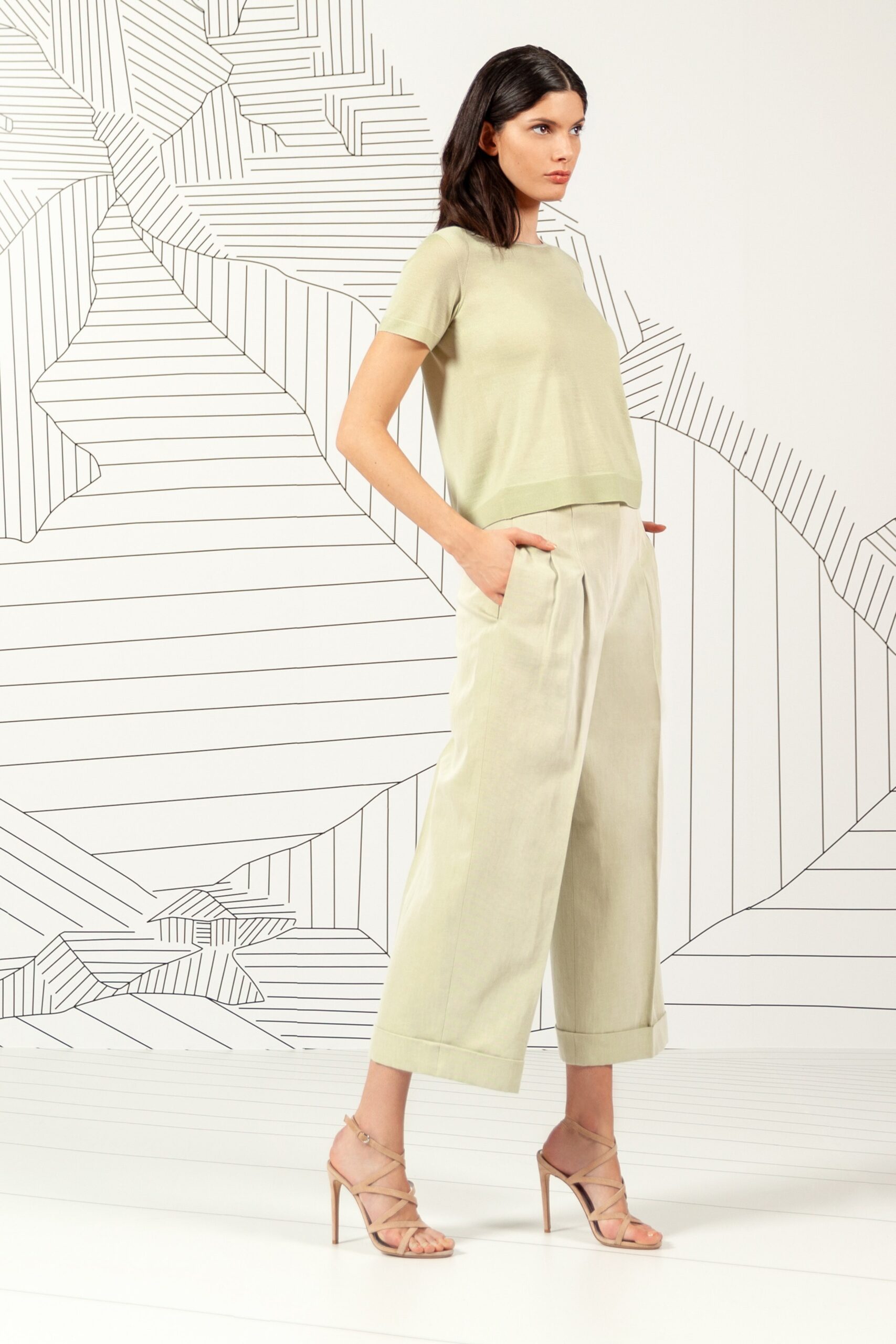 green cropped top with beige pants