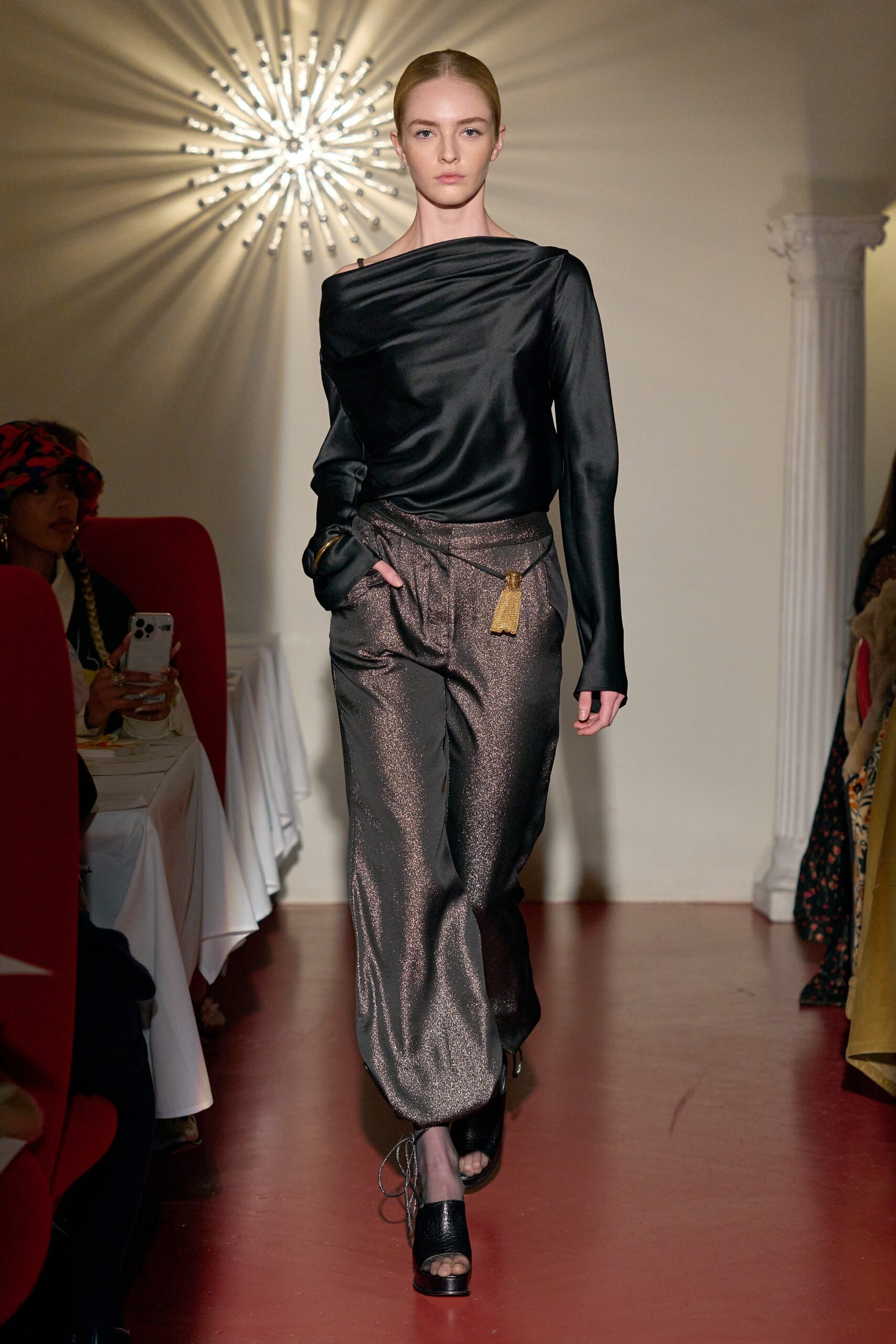 black silk off-shoulder top and brown wide-leg pants