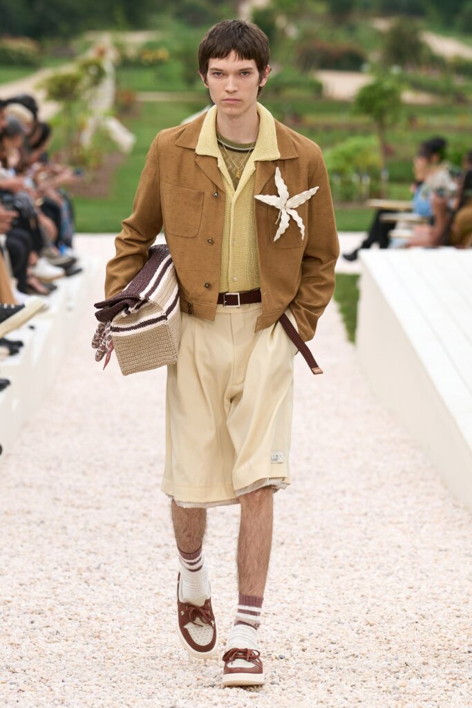 A relaxed brown cotton jacket with a collared neckline paired with beige shorts.