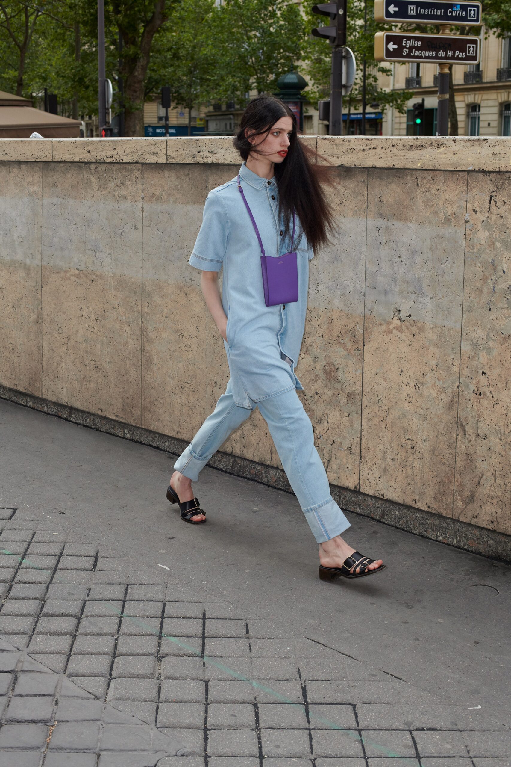 blue denim jumpsuit with purple bag