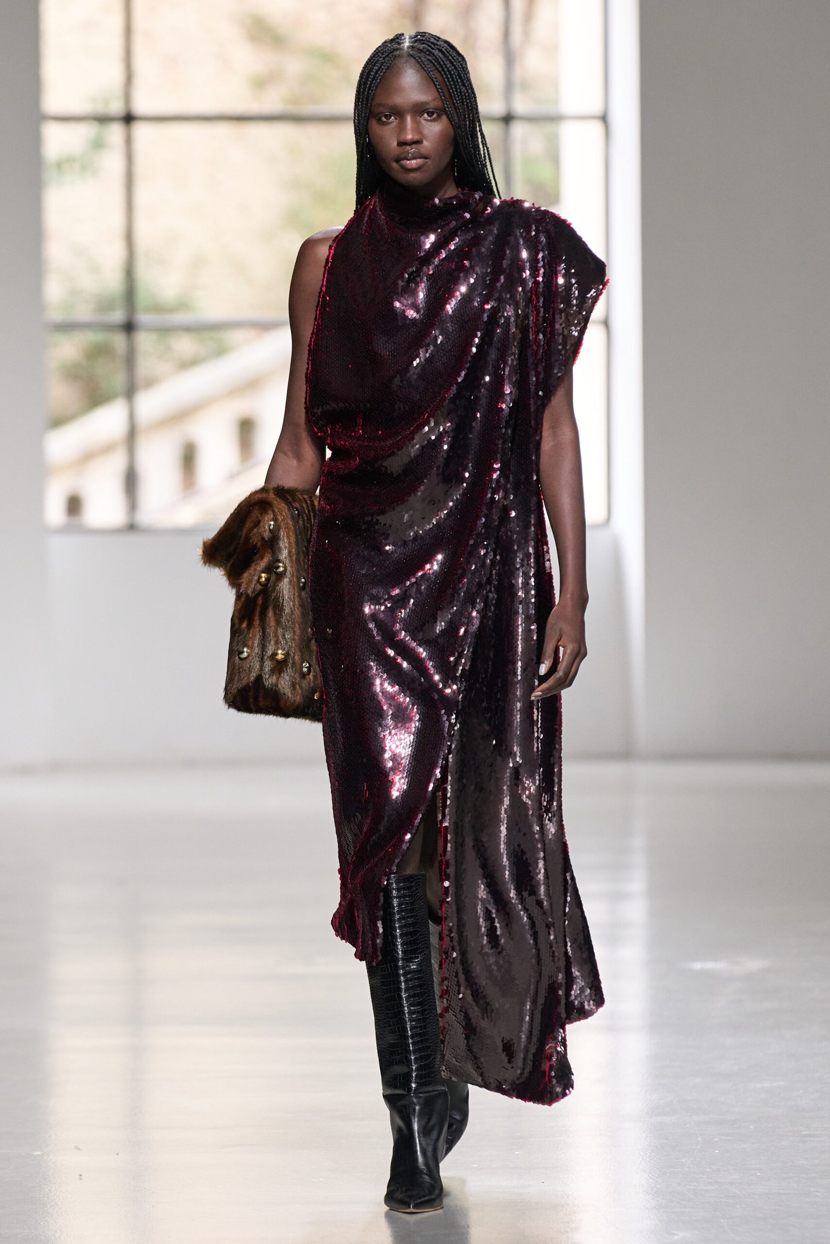 A fitted burgundy sequin dress with a sleeveless design and asymmetric silhouette.