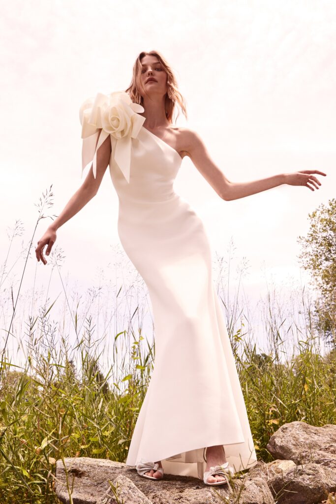 A fitted white silk dress with a sleeveless design and flared silhouette.