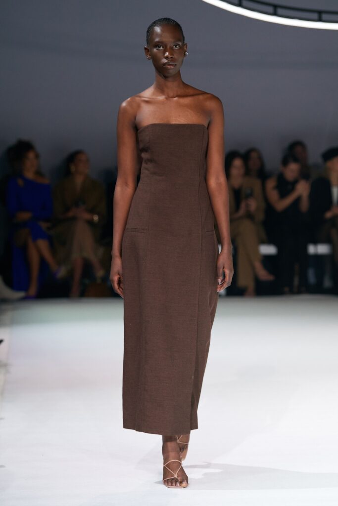 A fitted brown cotton strapless dress with a maxi silhouette.