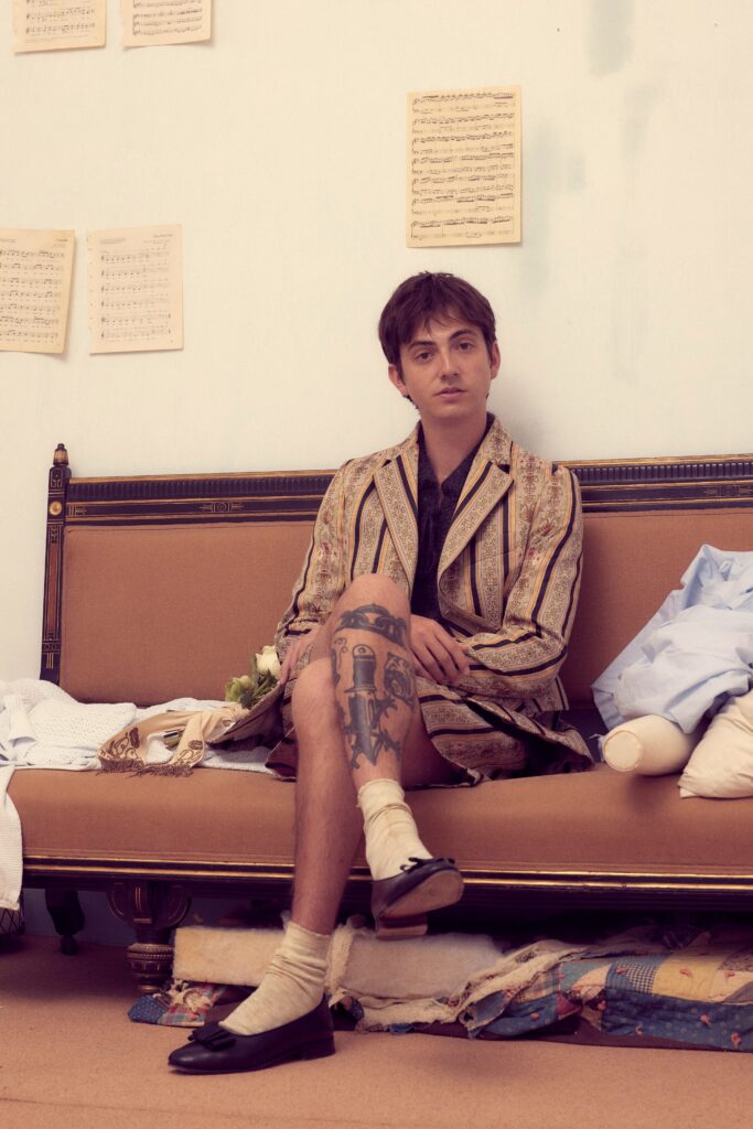 A relaxed beige striped jacket paired with casual shorts, showcasing a unique blend of styles.
