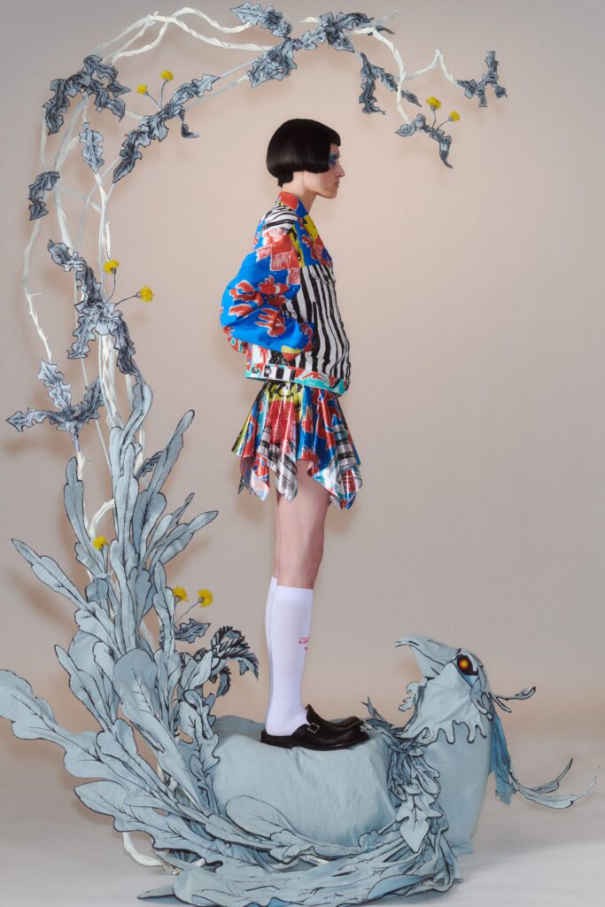 A fitted multicolor printed dress with a collared neckline and long sleeves.