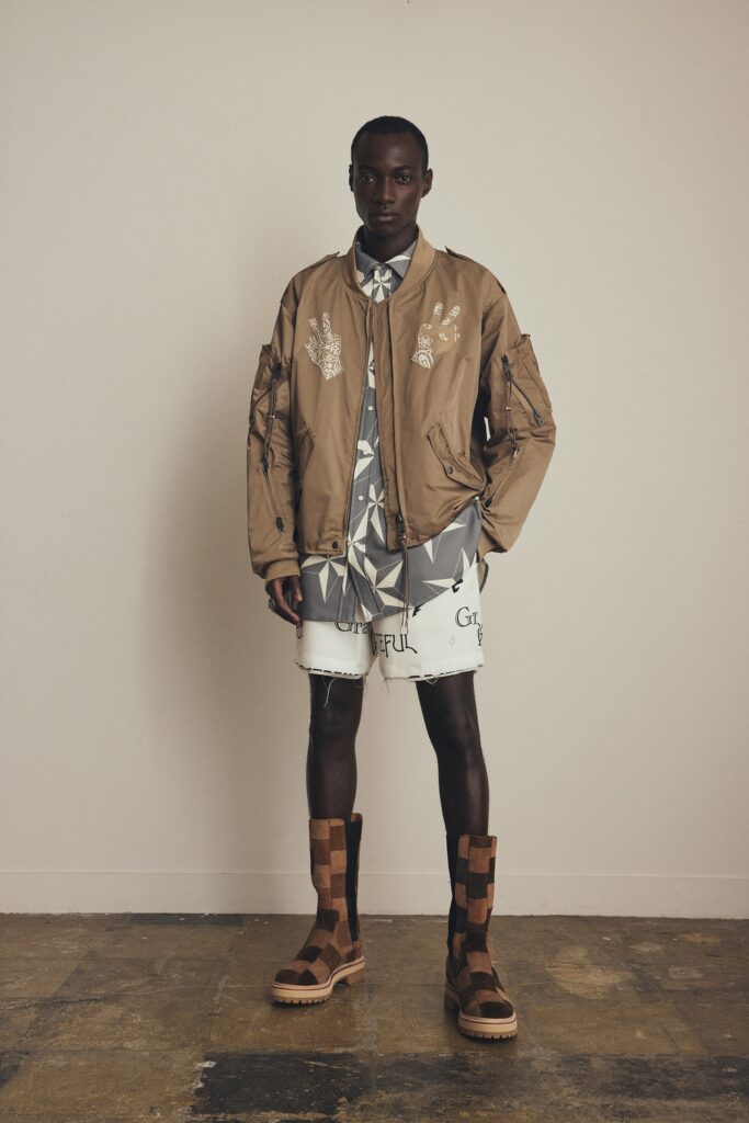 A relaxed beige jacket paired with a printed white shirt, perfect for casual wear.