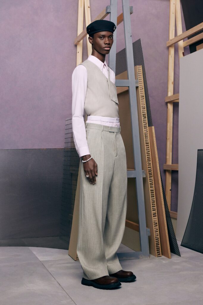 A tailored gray vest paired with wide-leg pants, creating a sophisticated and modern look.
