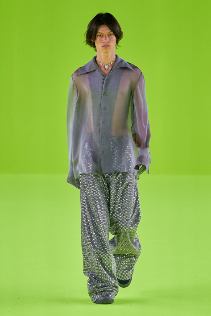 A relaxed purple sheer long-sleeve shirt paired with wide-leg silver pants.