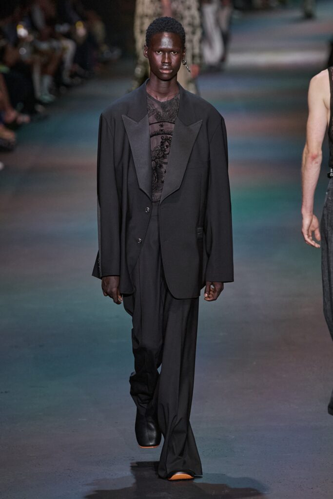An oversized black suit featuring a long-sleeve collared shirt and buttoned details.