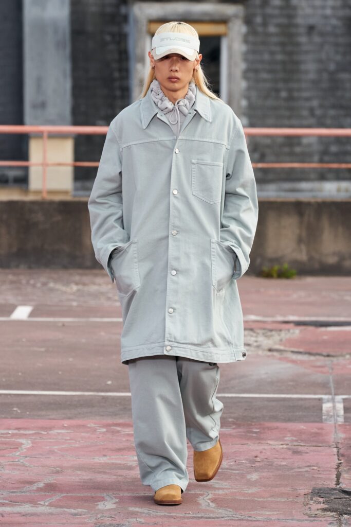 A relaxed gray cotton coat with long sleeves and collared design, paired with matching pants.