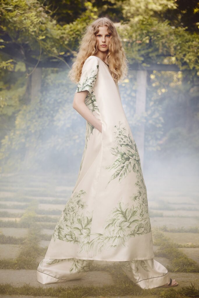 A relaxed cream silk short-sleeve dress with a high neckline and flared silhouette.