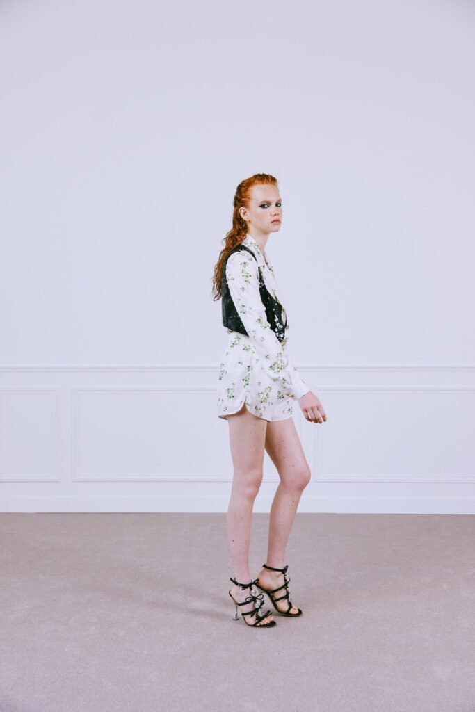 A fitted black and white floral long-sleeve vest paired with matching shorts.