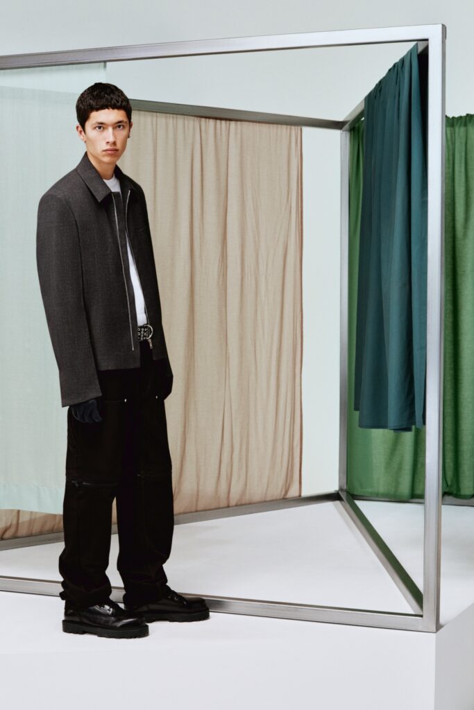 A relaxed gray jacket with a collared neckline paired with black pants.