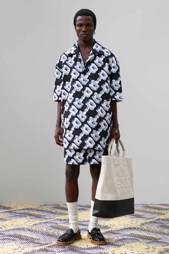A relaxed black and white printed shirt-dress with short sleeves and a collared neckline.