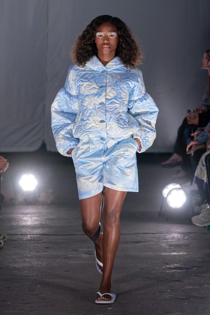 A relaxed blue printed jacket with long sleeves paired with matching shorts.