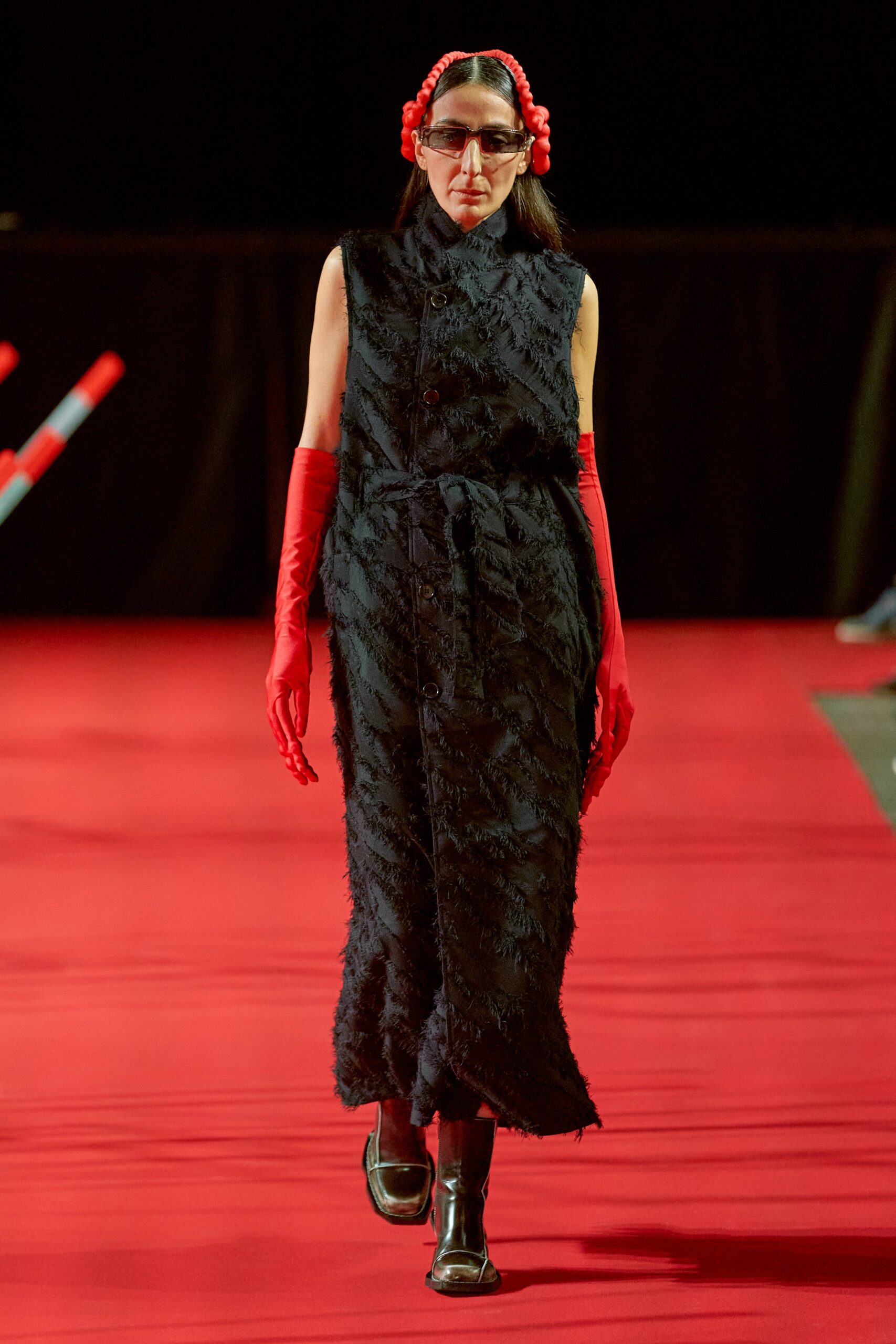 A relaxed black cotton dress with a collared neckline and buttoned tiered design.
