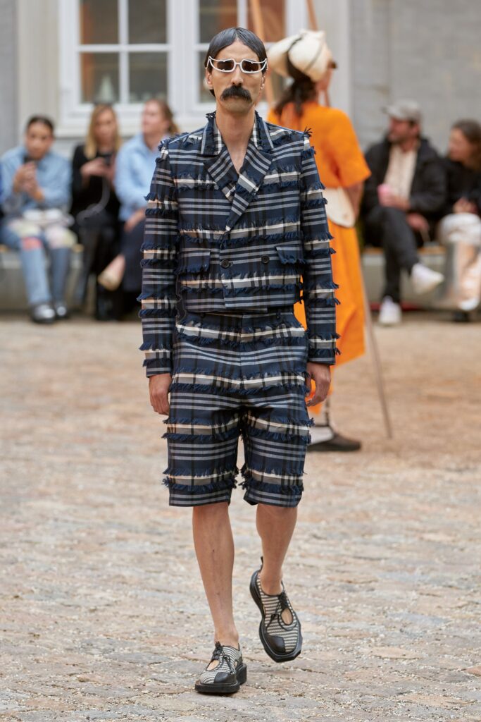 A relaxed blue checked suit with short sleeves and a collared design.