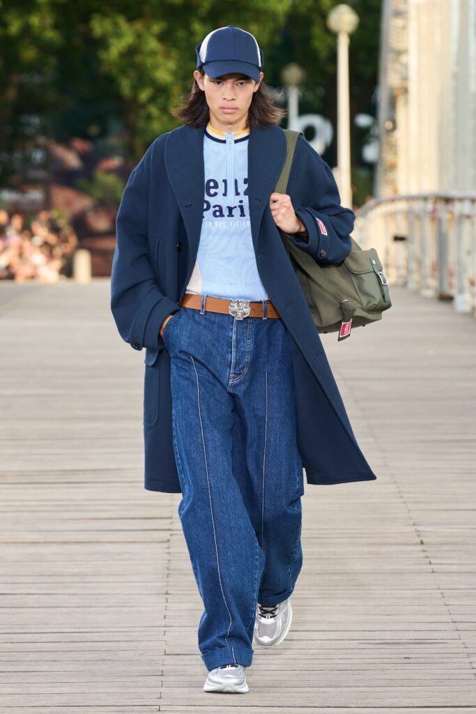 A relaxed navy jacket paired with wide-leg denim pants, featuring a collared design.