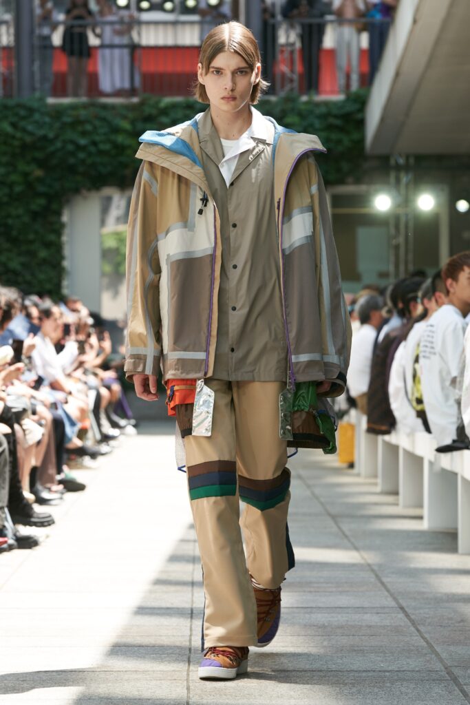 A relaxed beige jacket with multicolor details paired with matching pants.