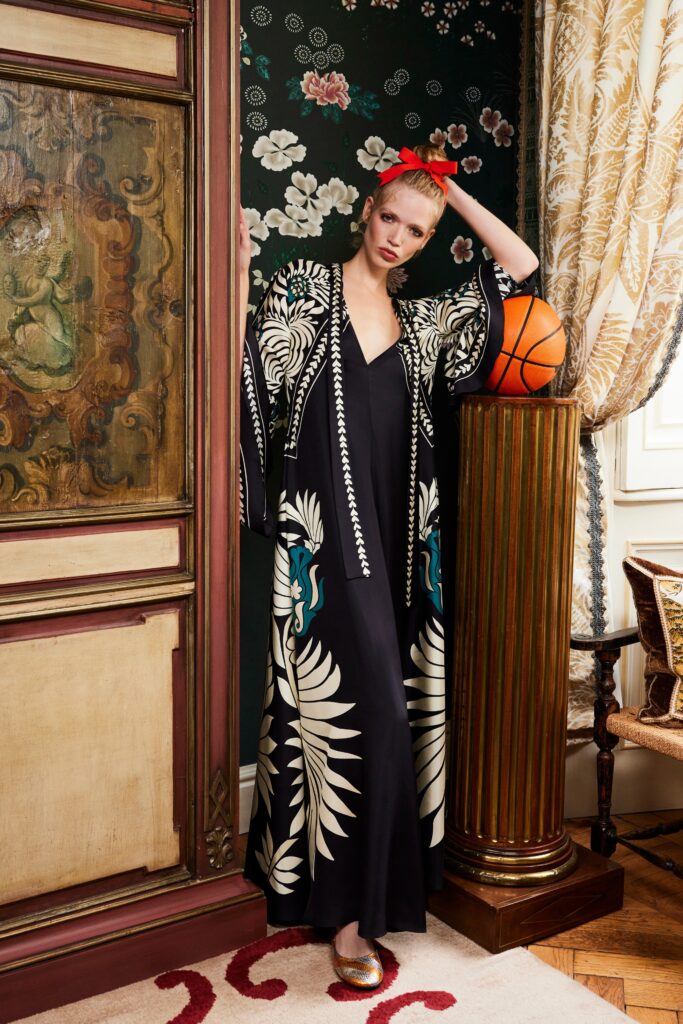A relaxed black silk dress with a sleeveless design and printed coat overlay.