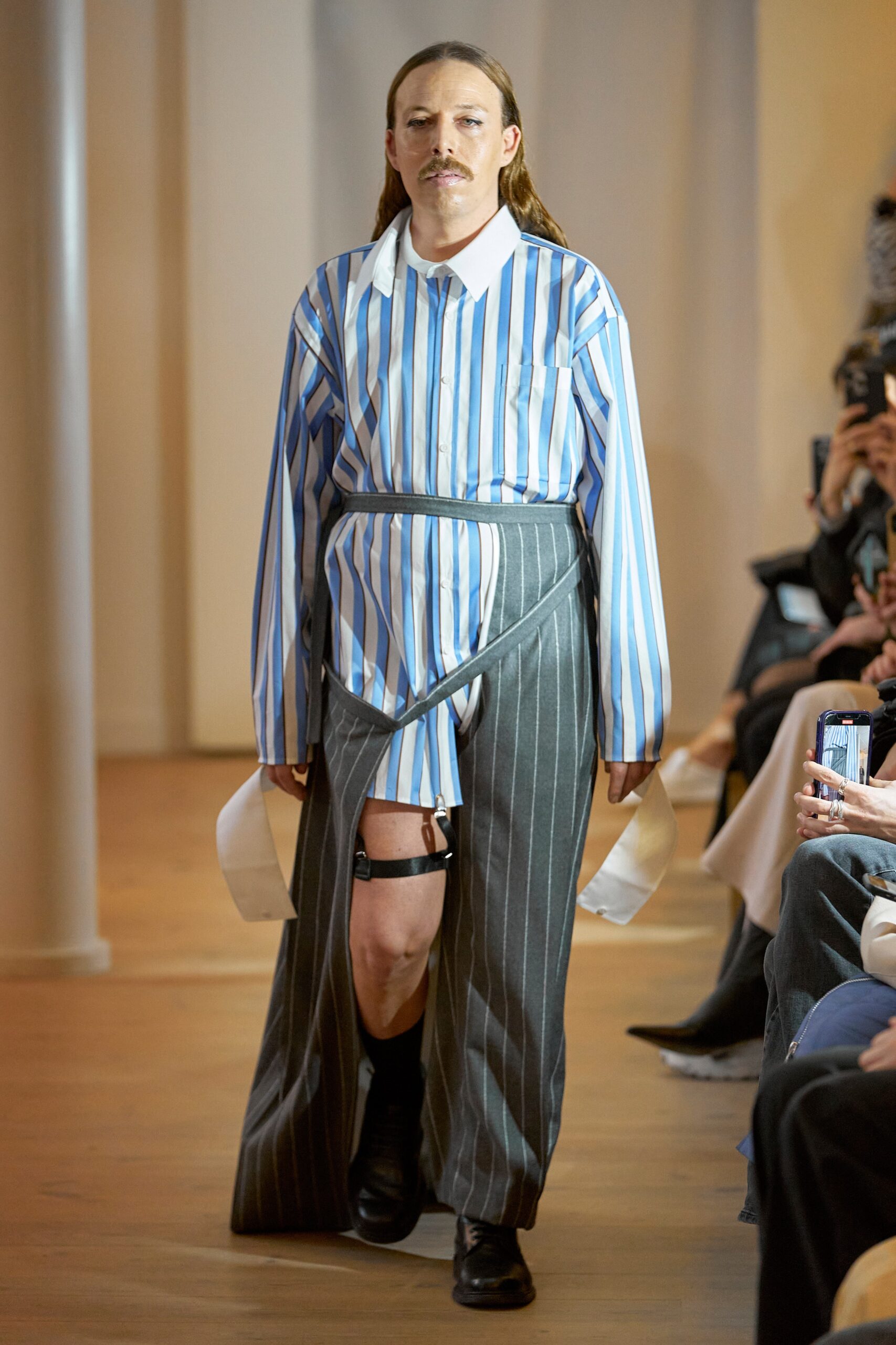 A relaxed fit long-sleeve collared shirt with stripes paired with an asymmetric skirt.
