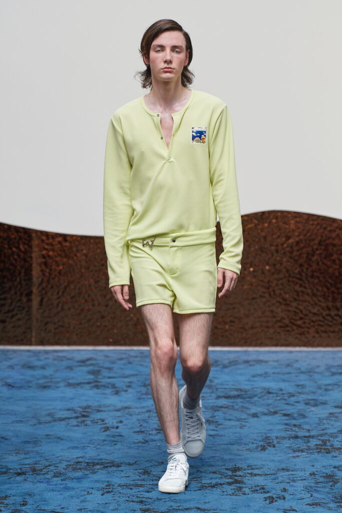 A fitted yellow cotton shirt with short sleeves and matching shorts, featuring a buttoned design.