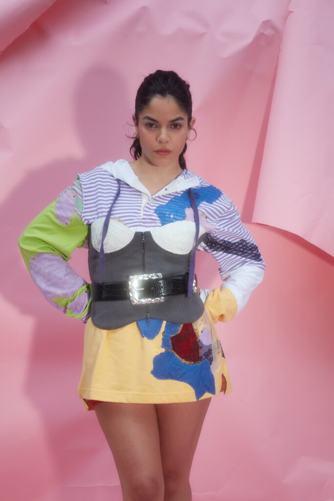 A fitted multicolor dress with a collared neckline and asymmetric design details.