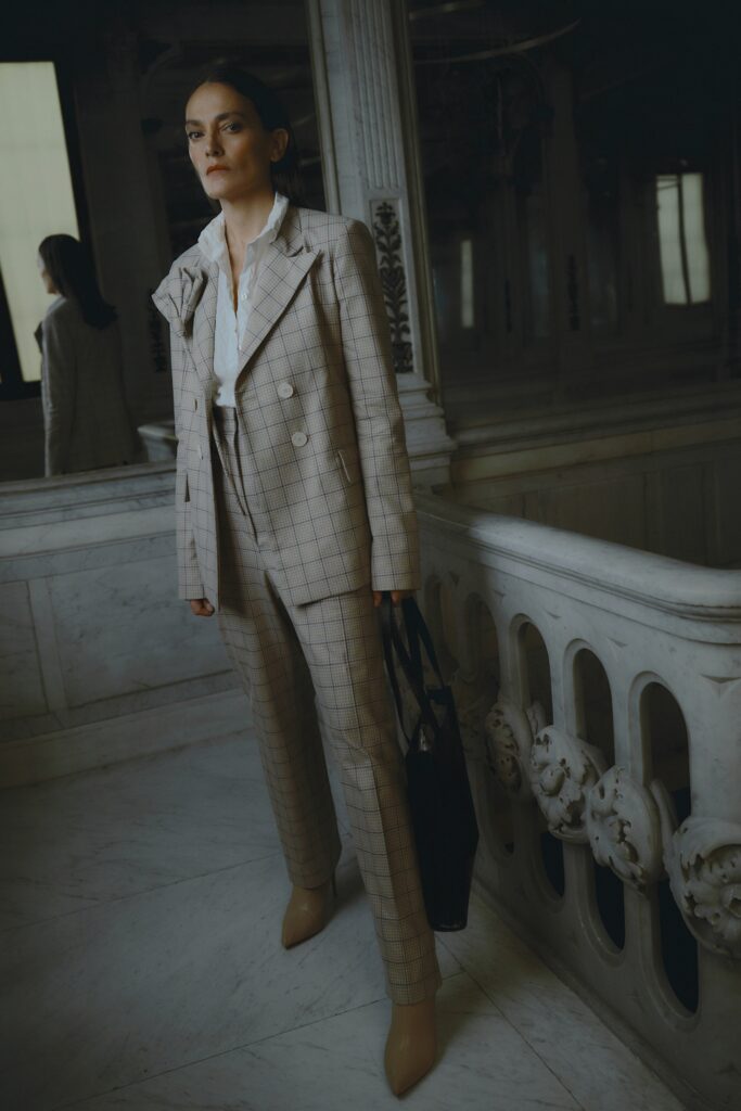A tailored beige checked suit with long sleeves and a collared shirt.