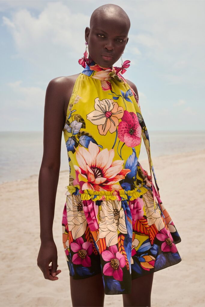 A relaxed yellow floral sleeveless dress with a high neckline and flared silhouette.
