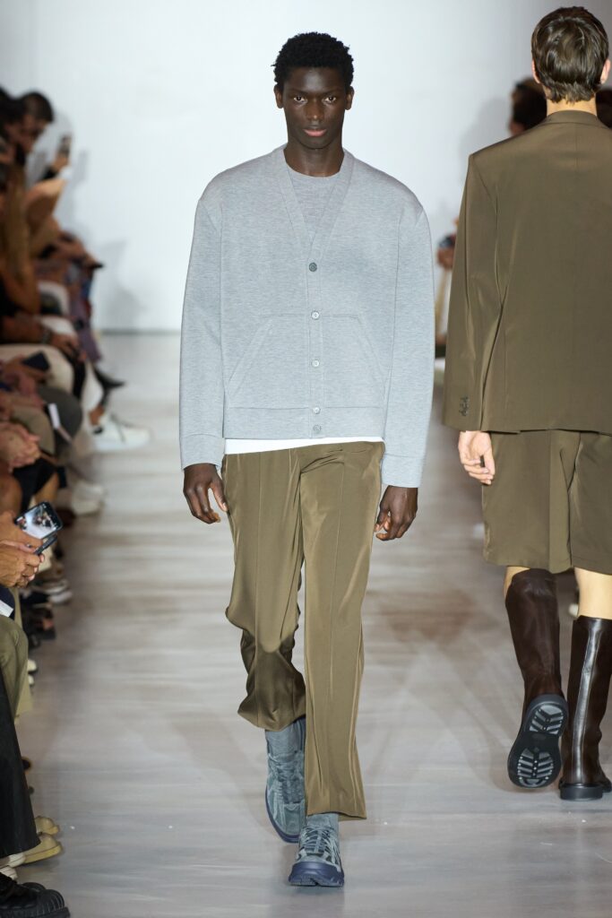 A relaxed gray cotton jacket with long sleeves and brown straight-leg pants.
