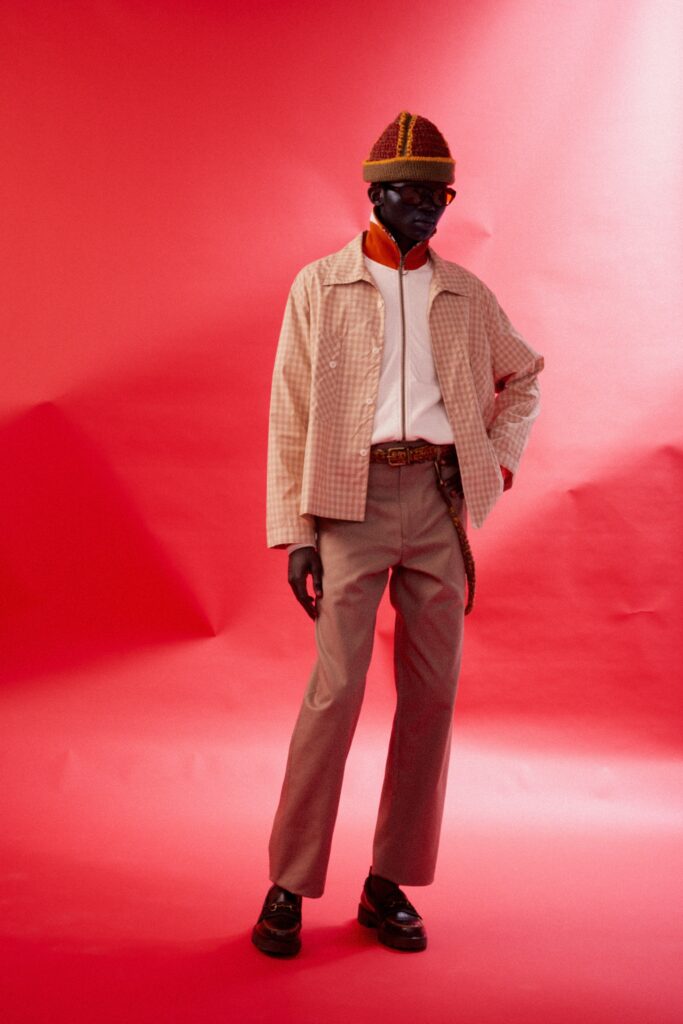 A relaxed beige checked jacket paired with straight-leg brown pants for a stylish look.