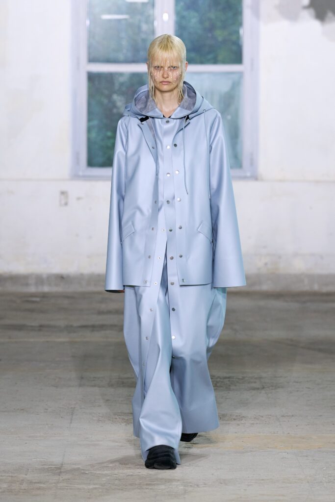 A relaxed blue leather coat with a hood and matching pants featuring a zippered detail.