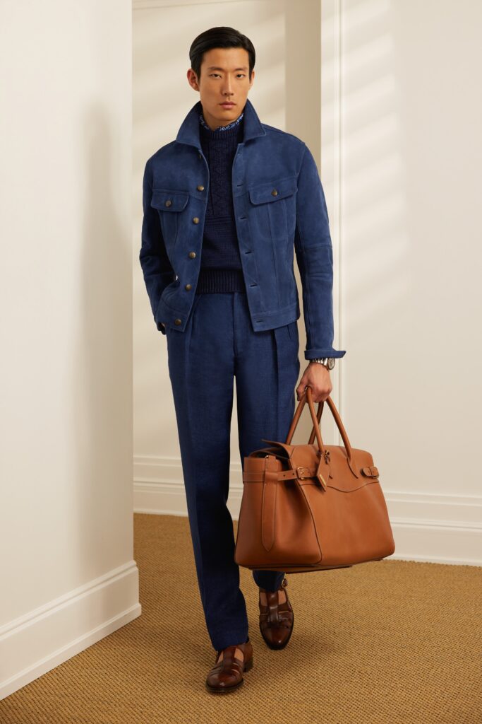 A tailored blue suede jacket with long sleeves and collared design paired with matching pants.