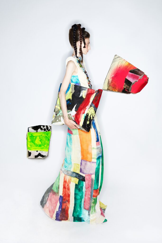 A fitted multicolor cotton sleeveless dress with a high neckline and tiered design.