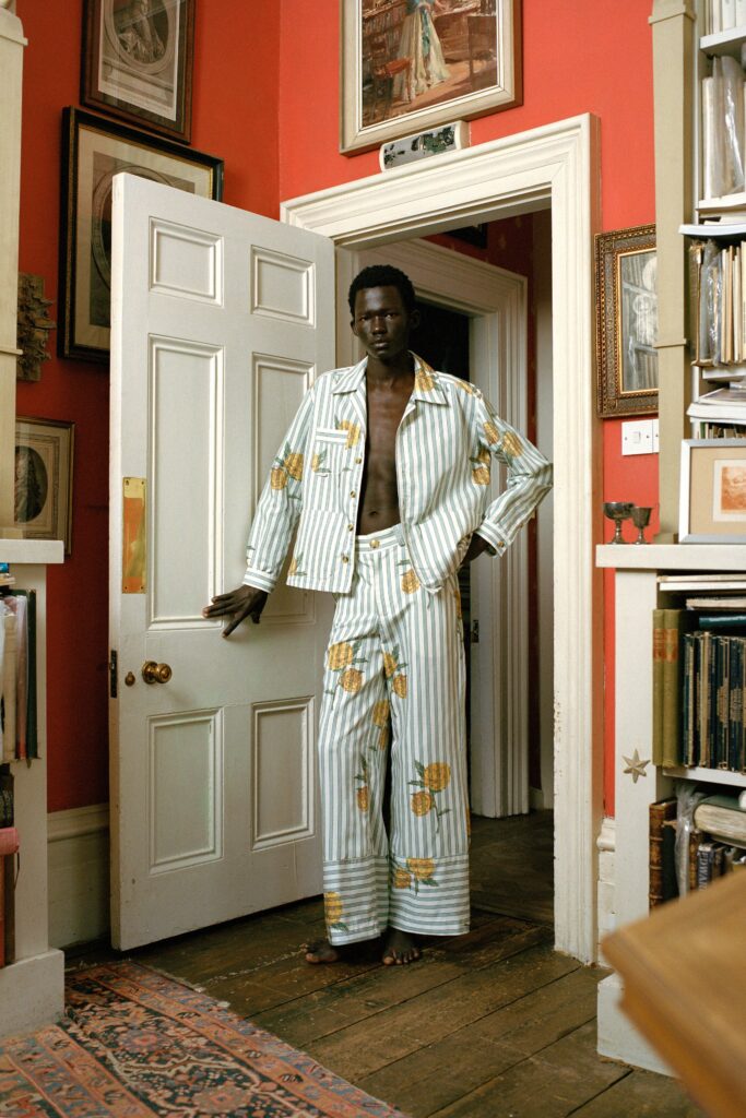 A relaxed fit white and blue striped jacket with matching pants featuring floral prints.