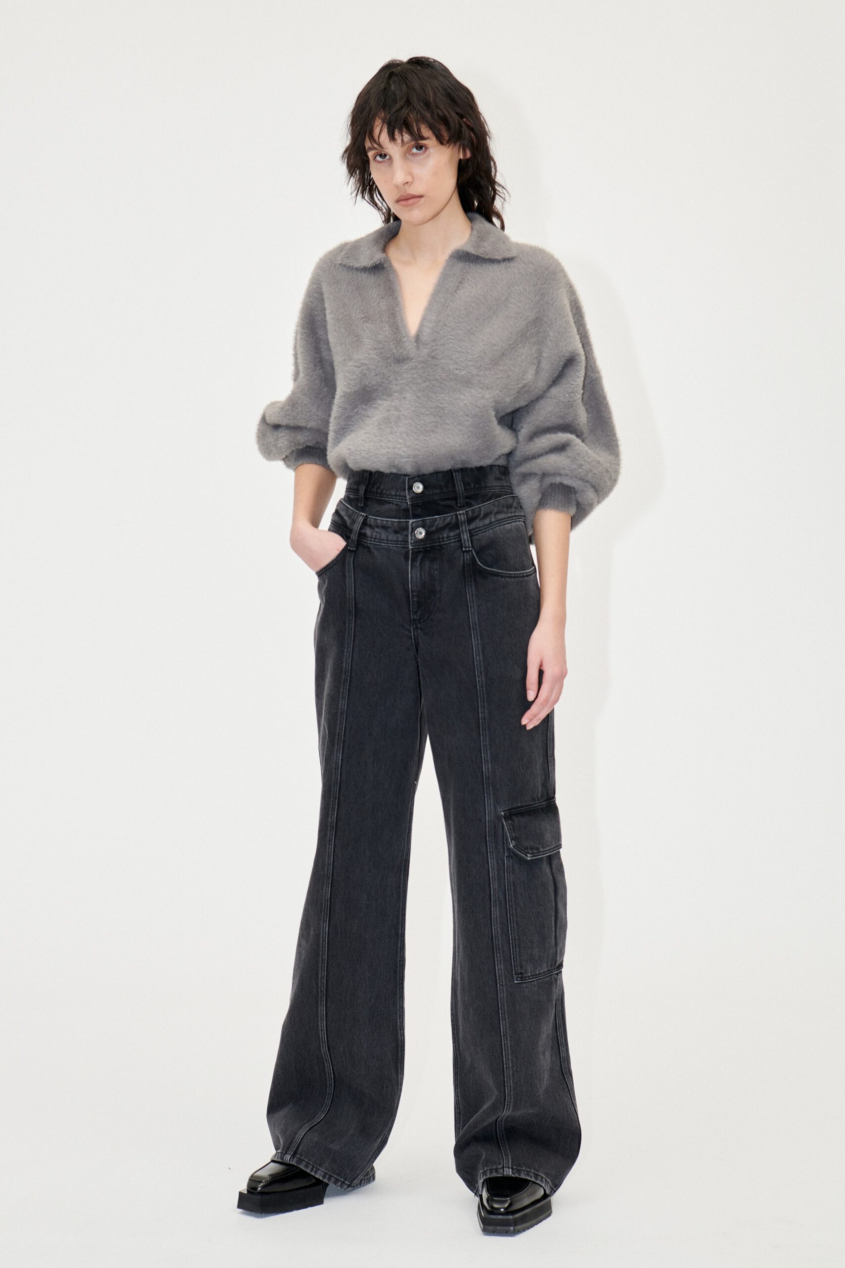 gray wool relaxed top and black denim pants