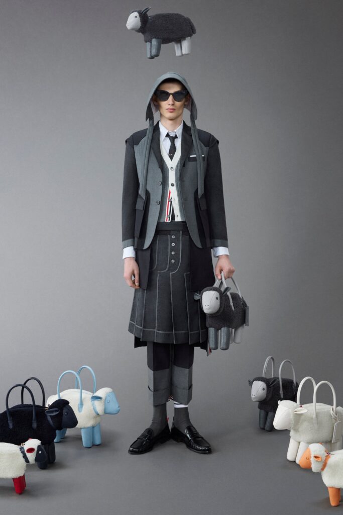 A structured black and gray jacket paired with a high-waisted asymmetric skirt.