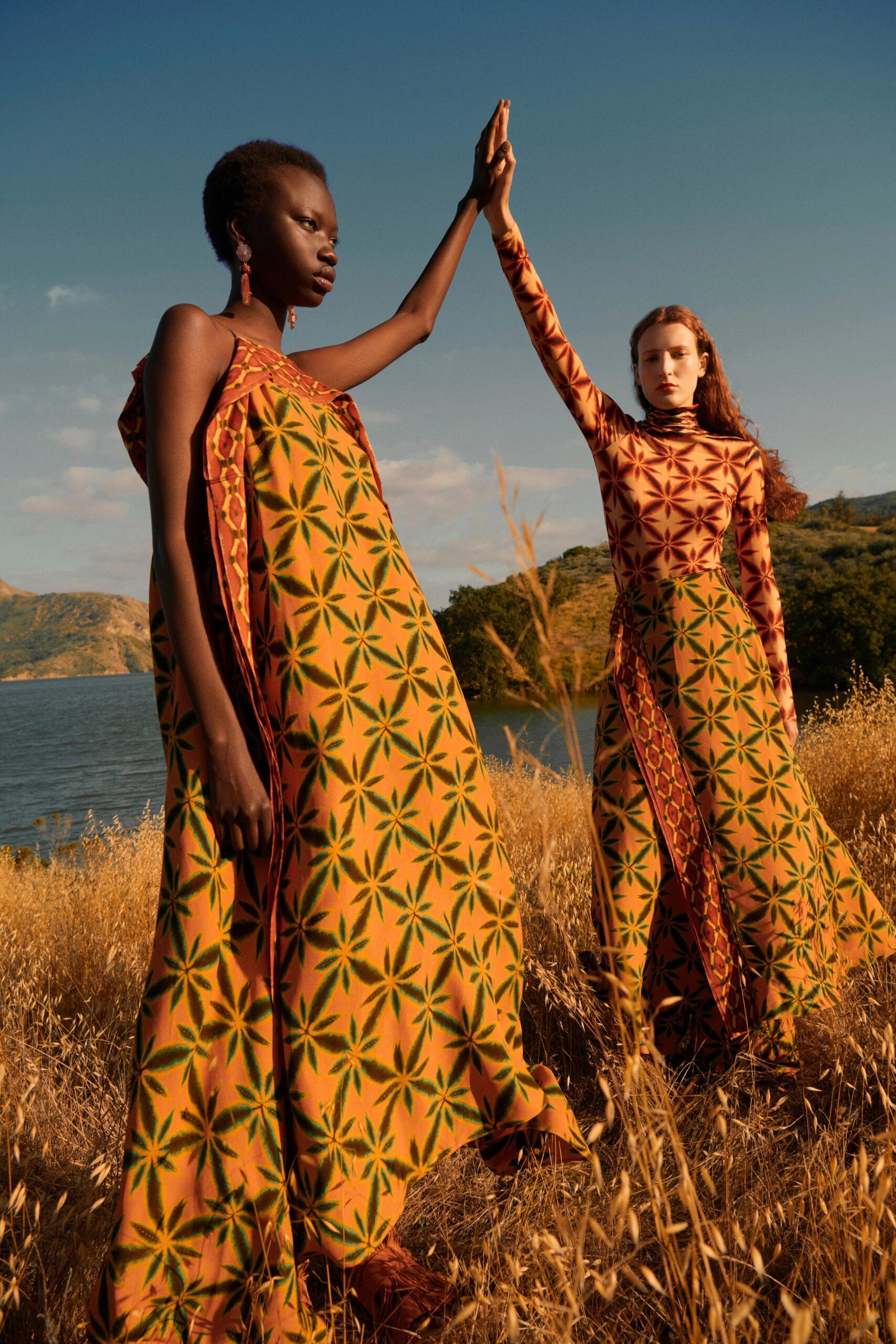 A relaxed sleeveless cotton dress featuring a high-neck and tiered design with vibrant prints.
