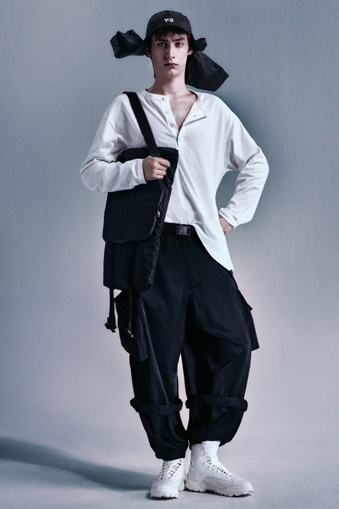 A relaxed white long-sleeve collared shirt paired with relaxed black pants.