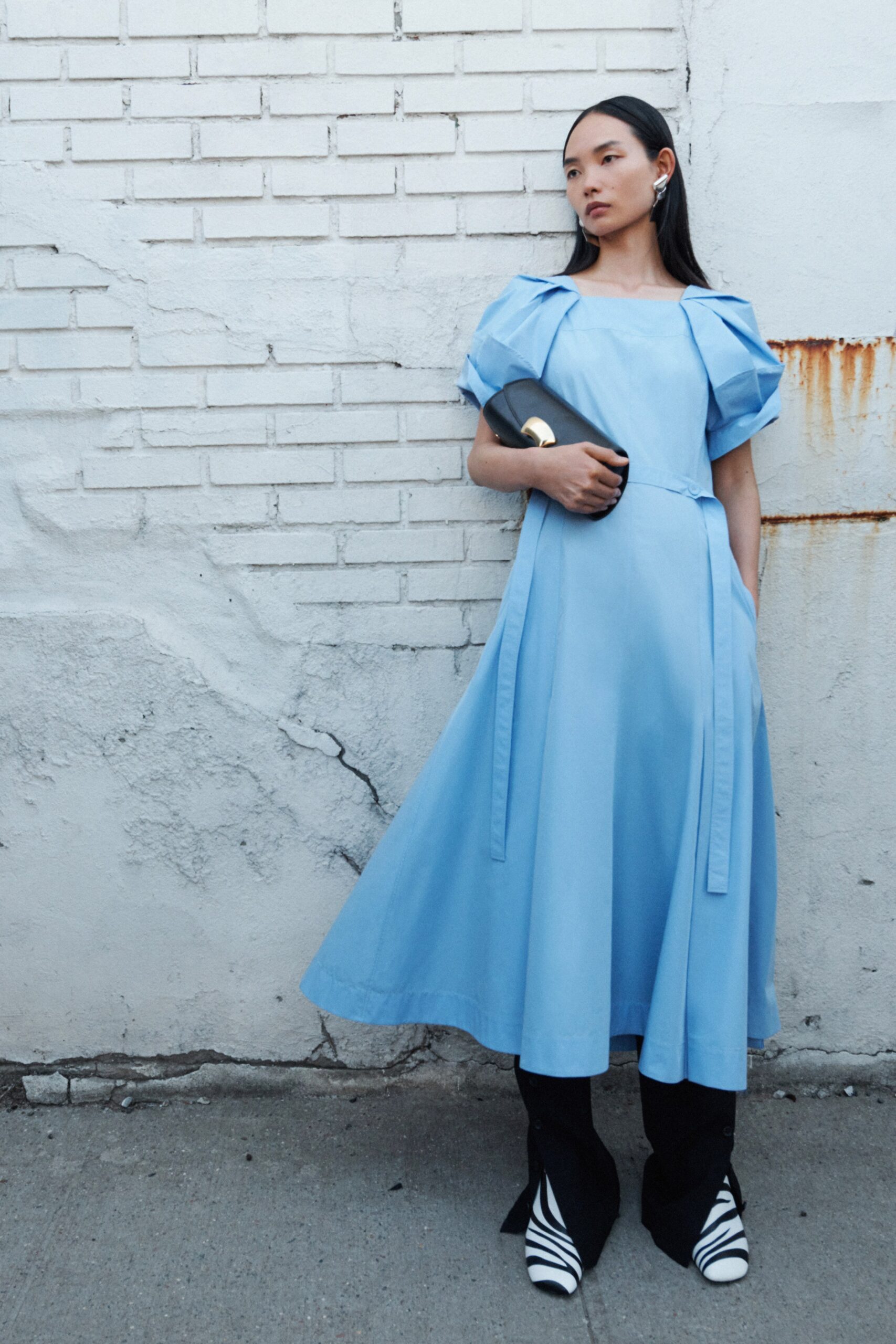 A fitted blue cotton short-sleeve dress with a high neckline and A-line silhouette.