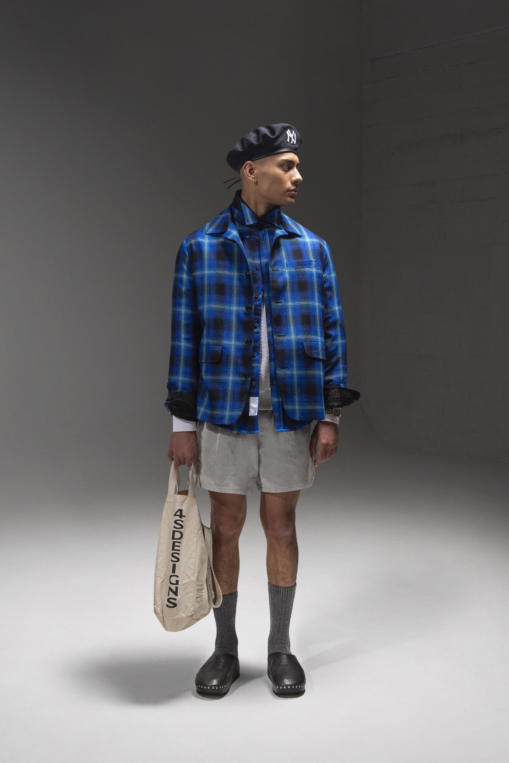 A relaxed blue checked jacket paired with gray shorts, featuring a collared design.