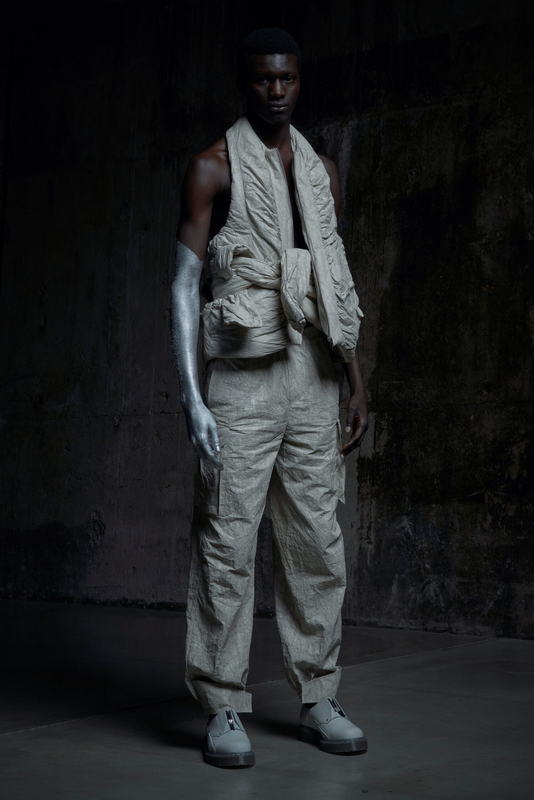 A relaxed beige cotton jacket layered over a sleeveless top, paired with matching pants.