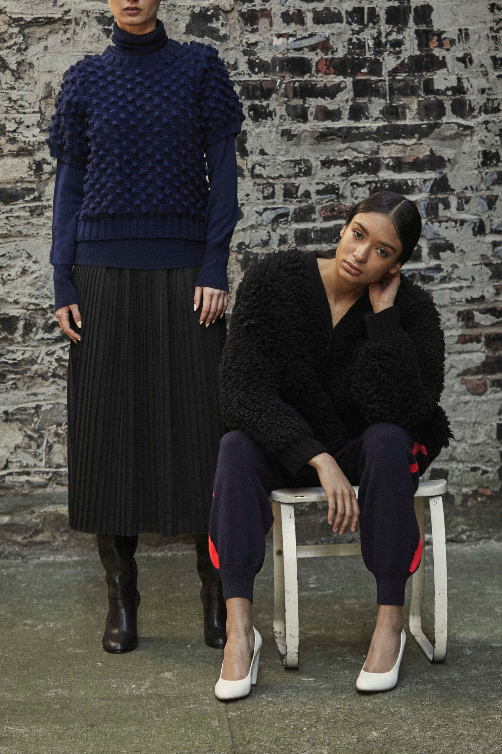 blue textured sweater and black pleated skirt