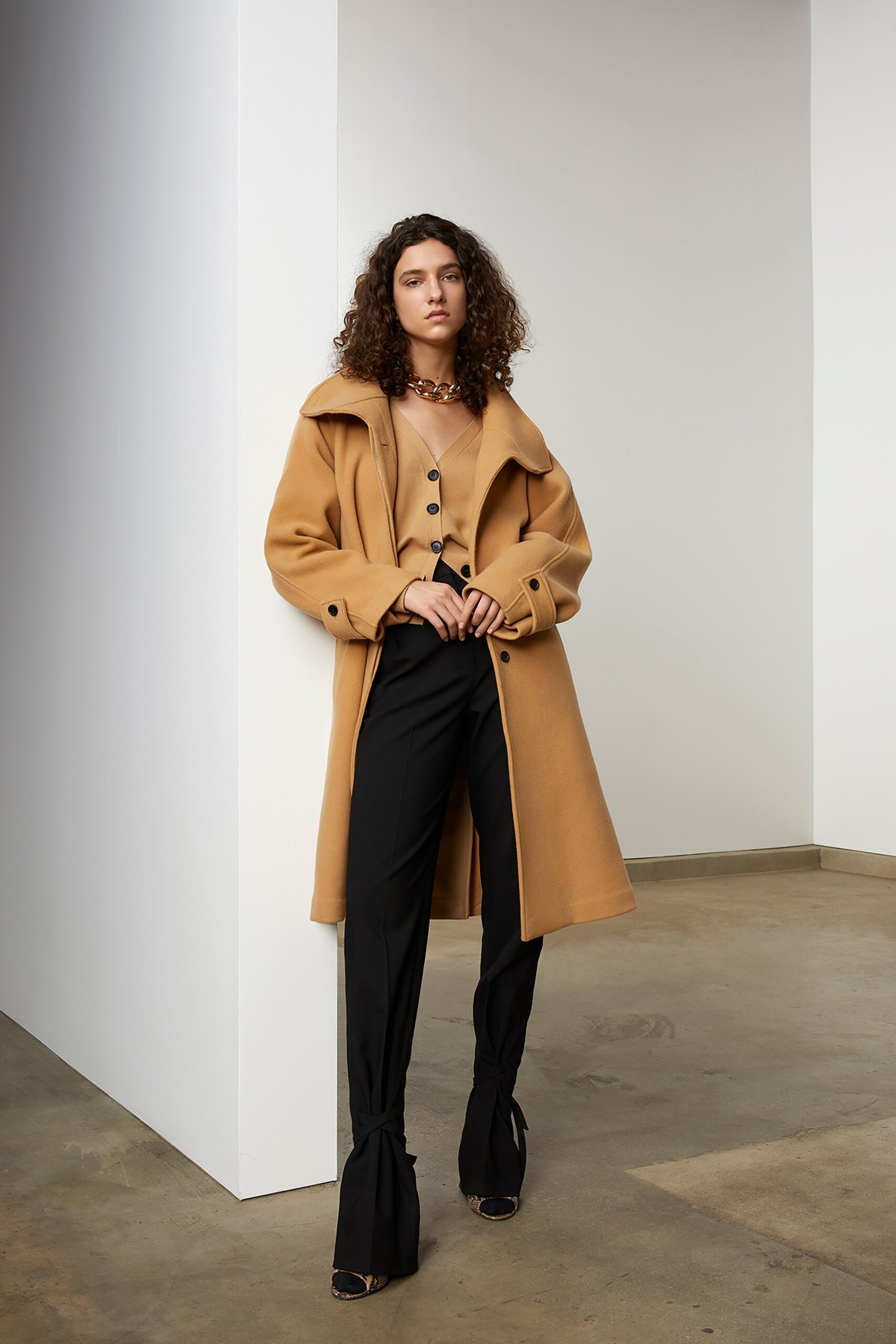 beige wool coat and black pants
