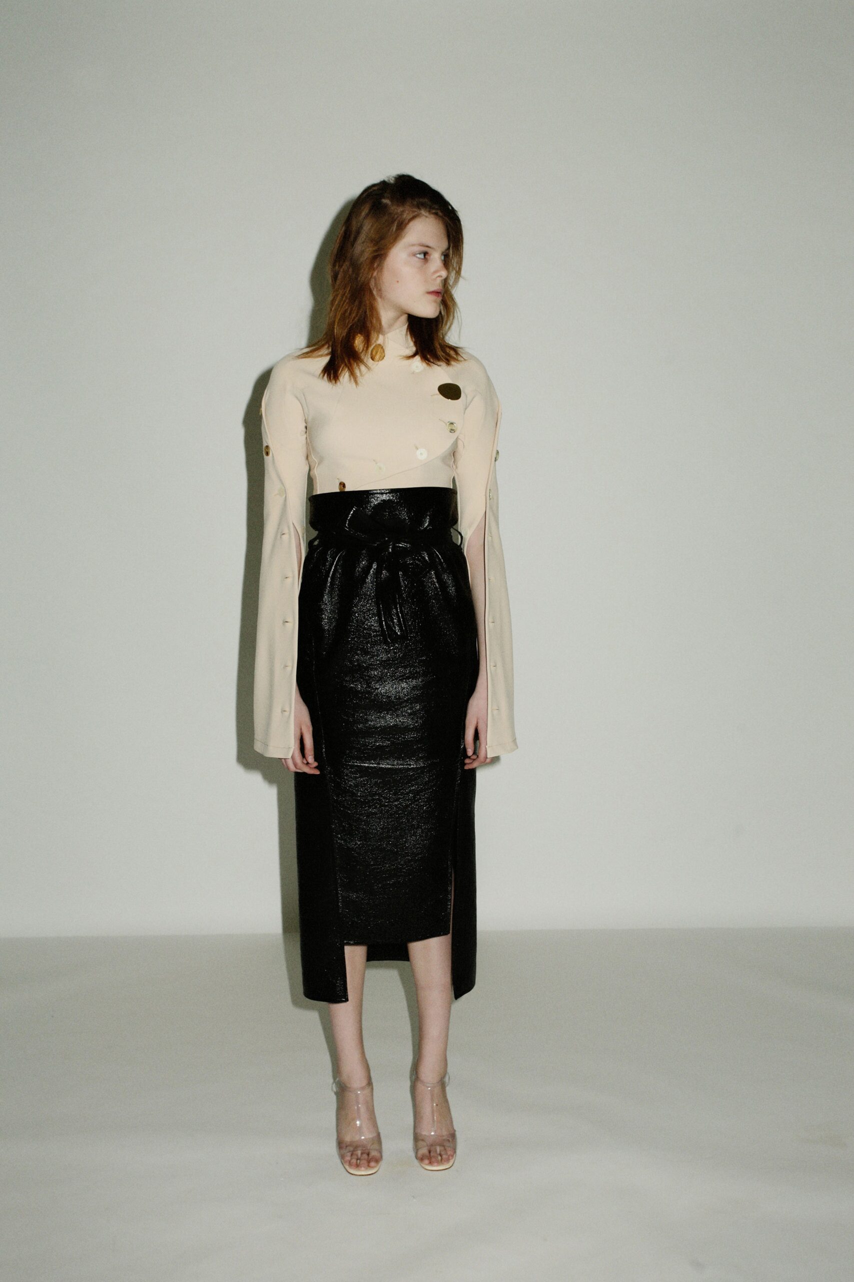 beige silk fitted top and black leather midi skirt