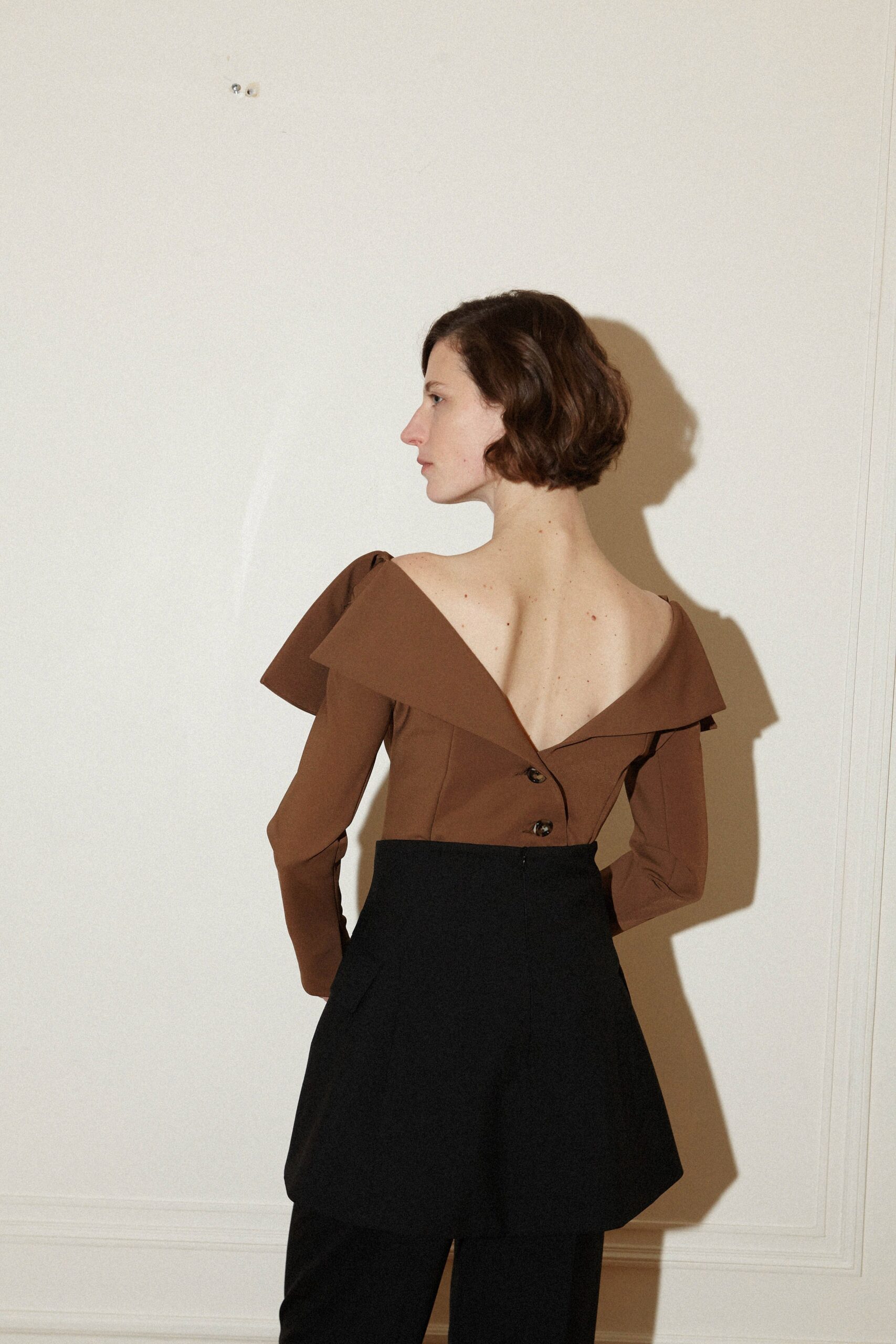 brown off-shoulder blouse with black tailored pants