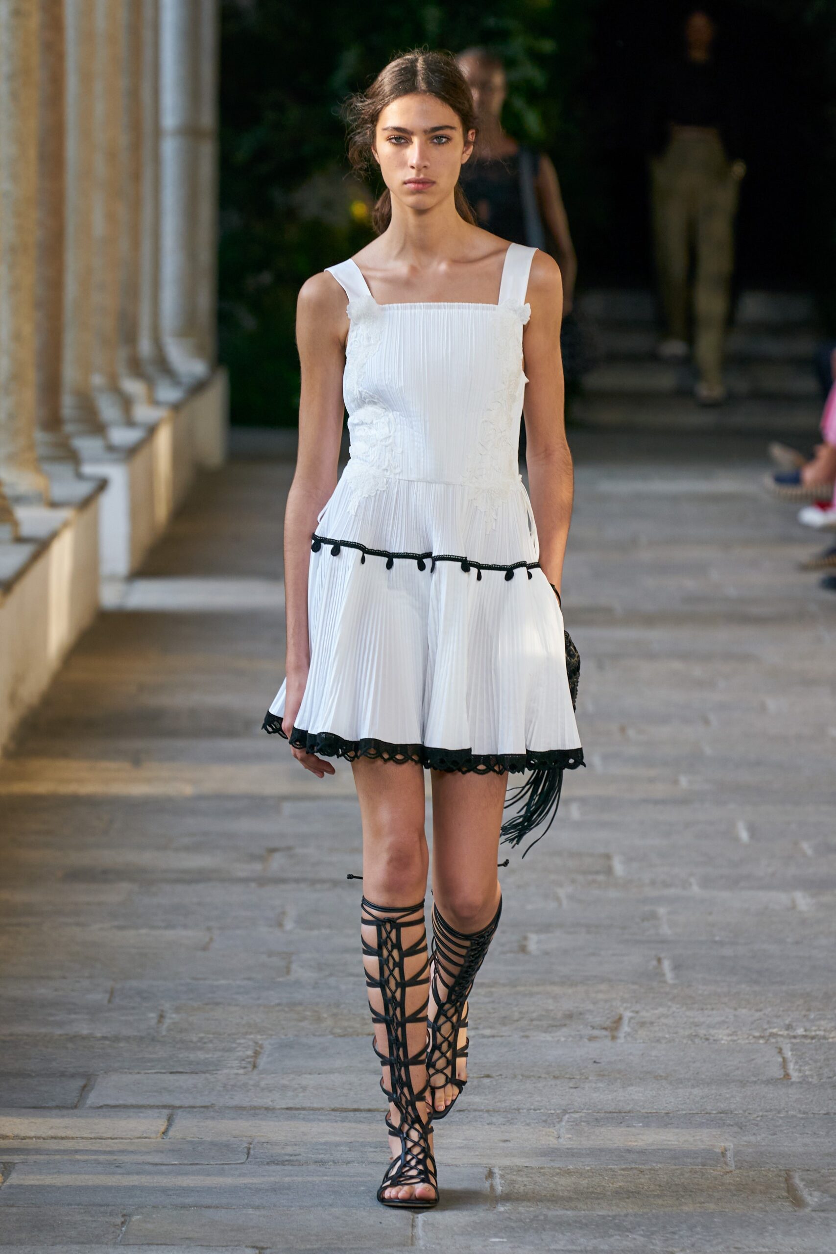 white pleated mini dress with black lace-up shoes
