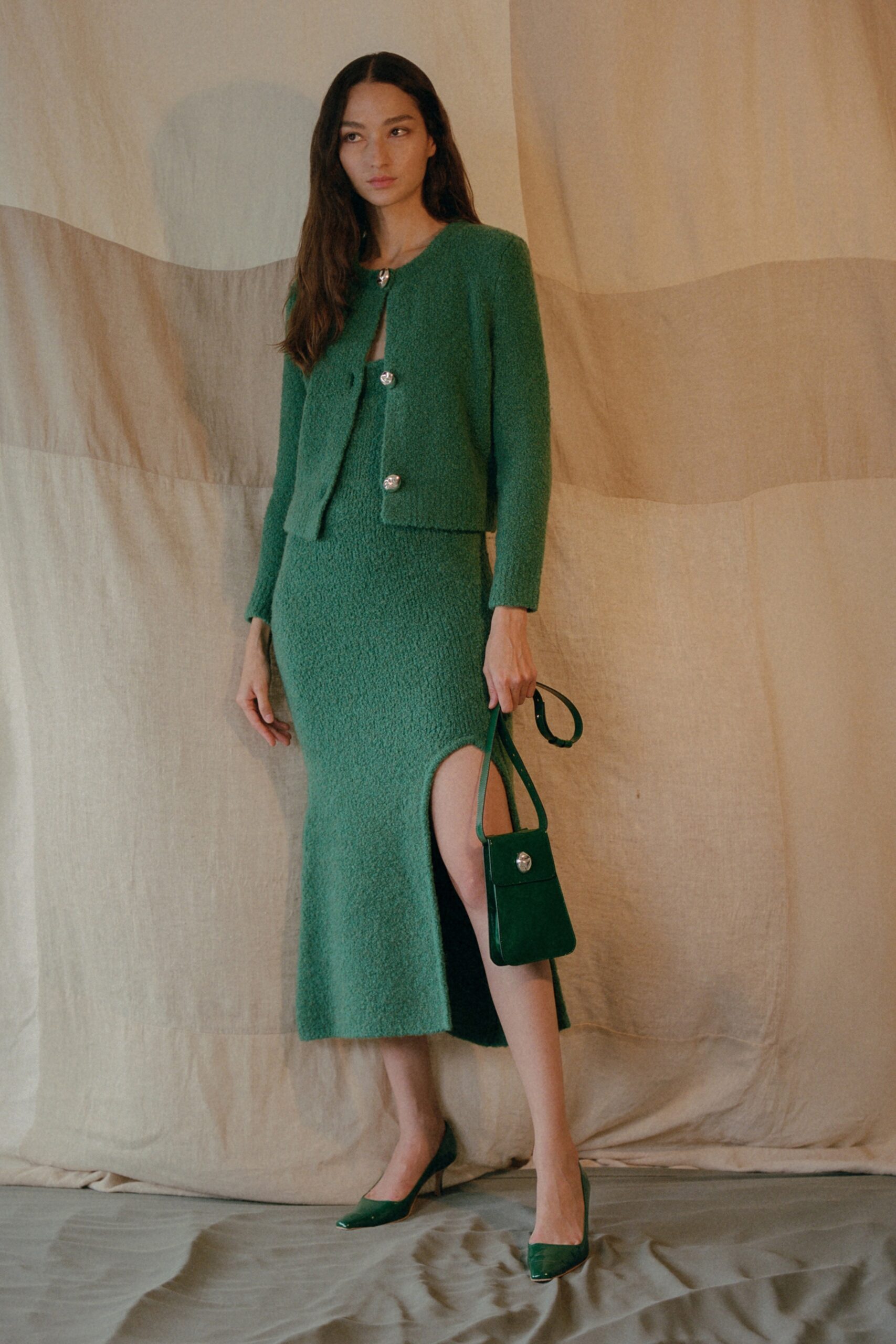 green fitted blazer and skirt