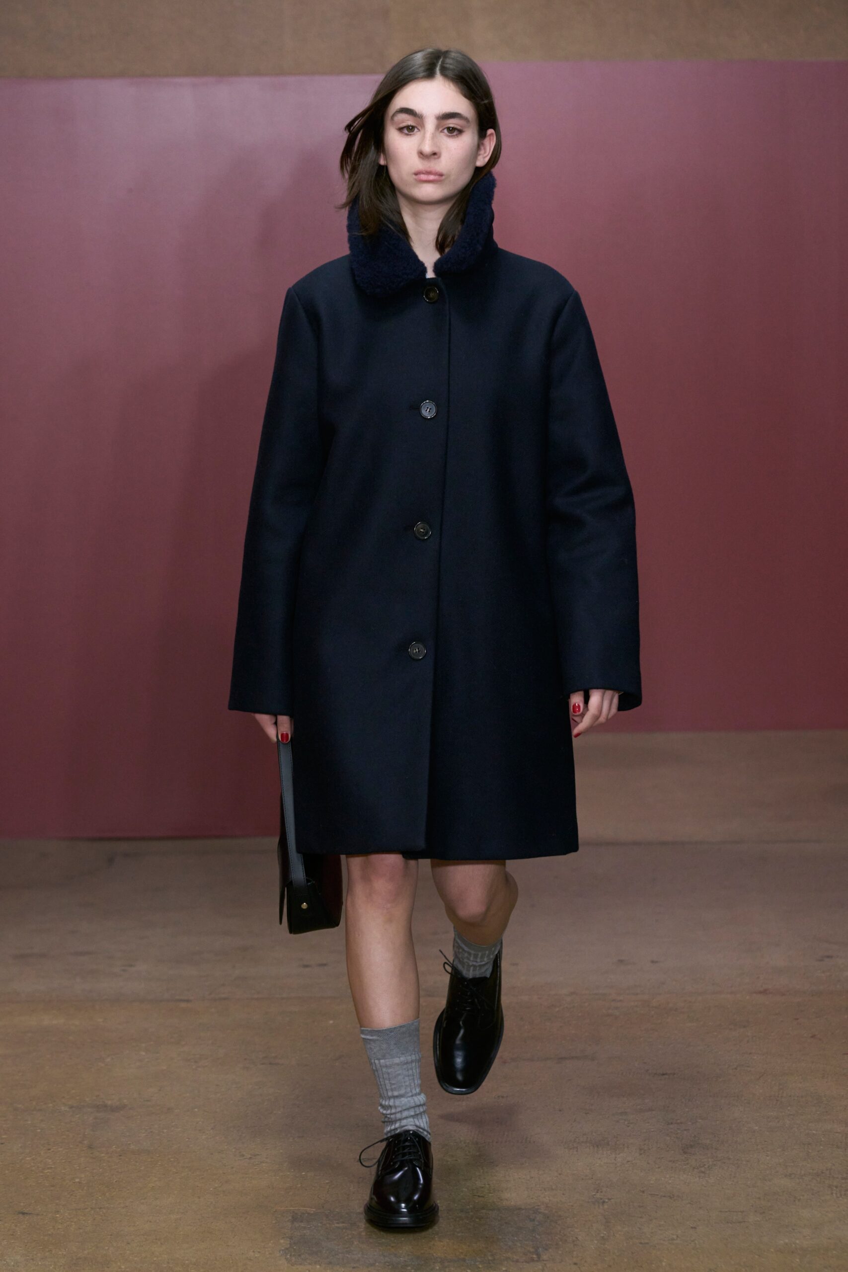 A relaxed navy wool coat with a collared neckline and buttoned front.